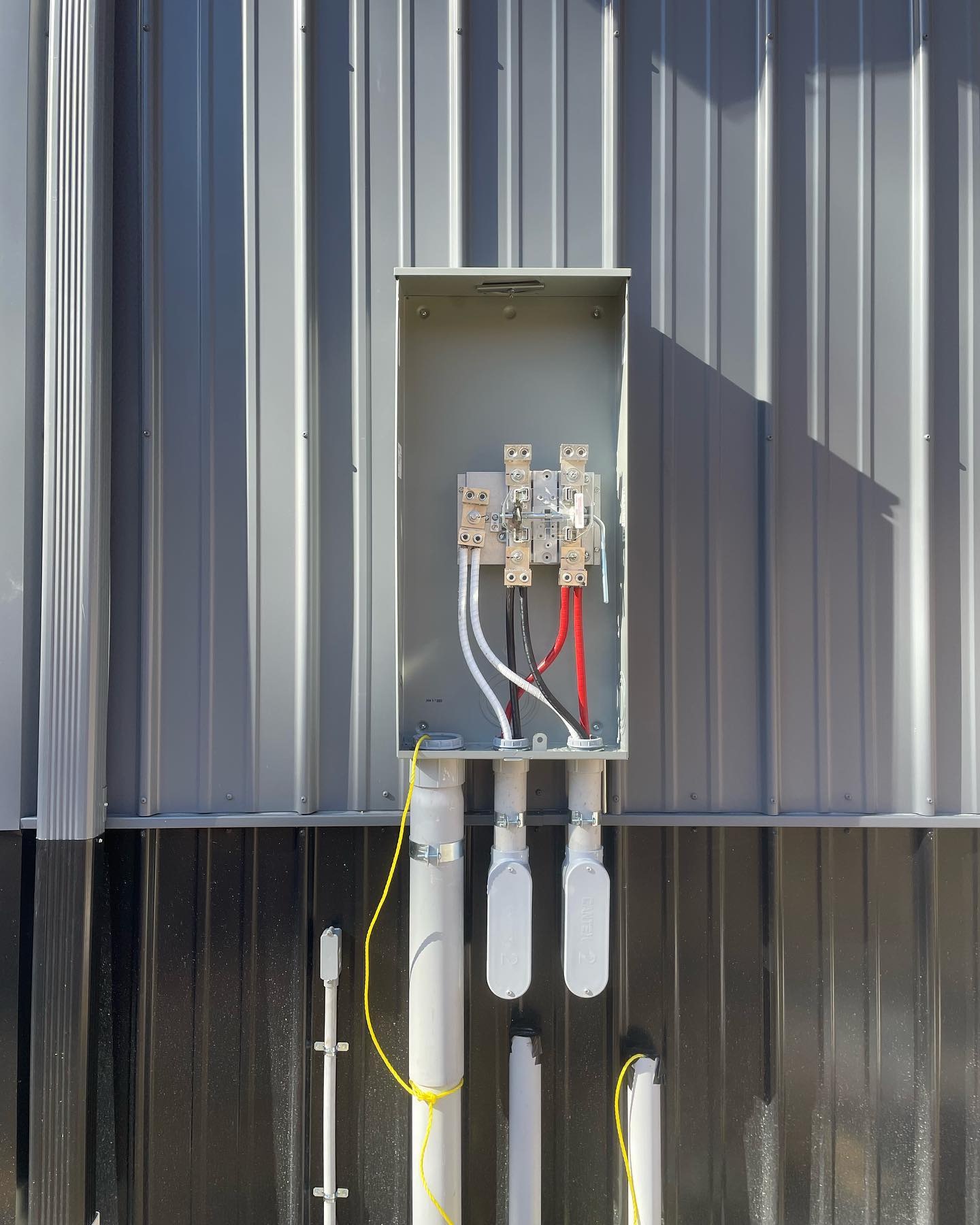 Commercial electrical service equipment on a metal building
