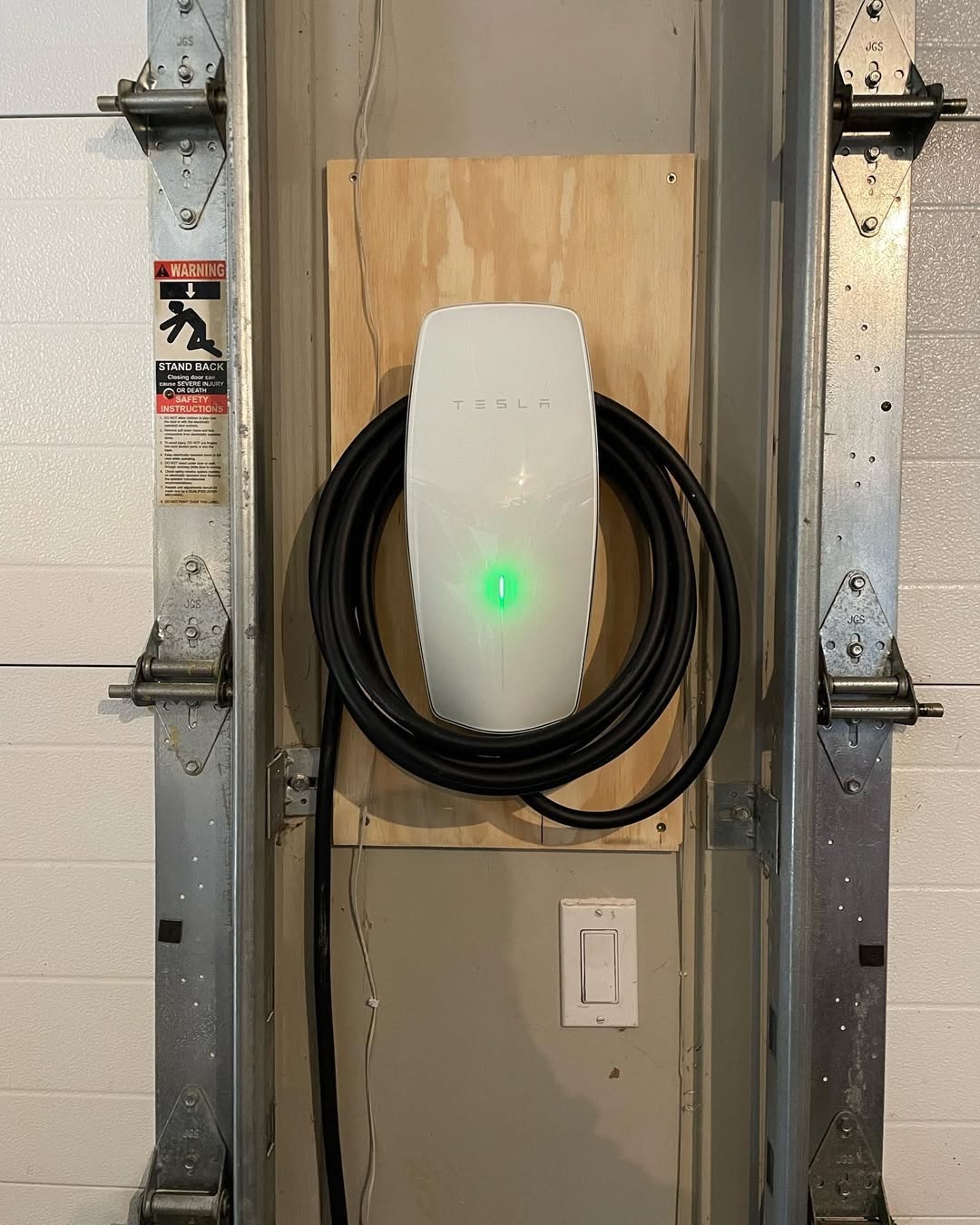 Tesla wall connector installed in a garage